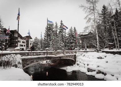 A Snow Covered Bridge And River In Vail, Colorado During Winter. 