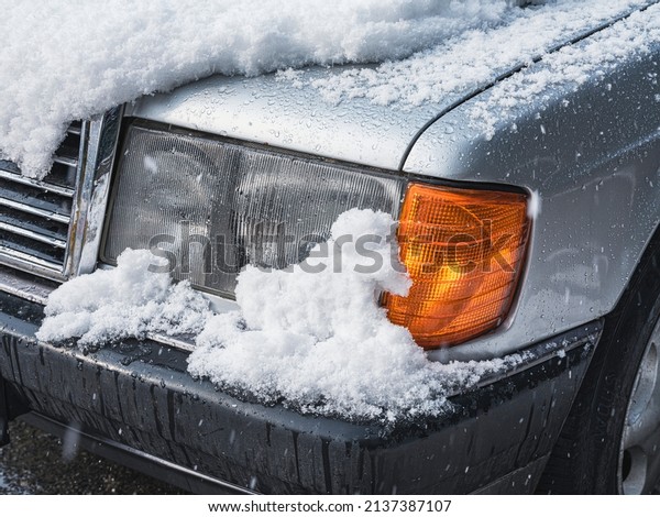 snow covered car\
headlight, close up