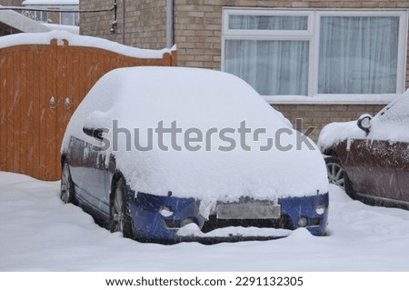 Snow covered car on a Decembers day in Surrey. 