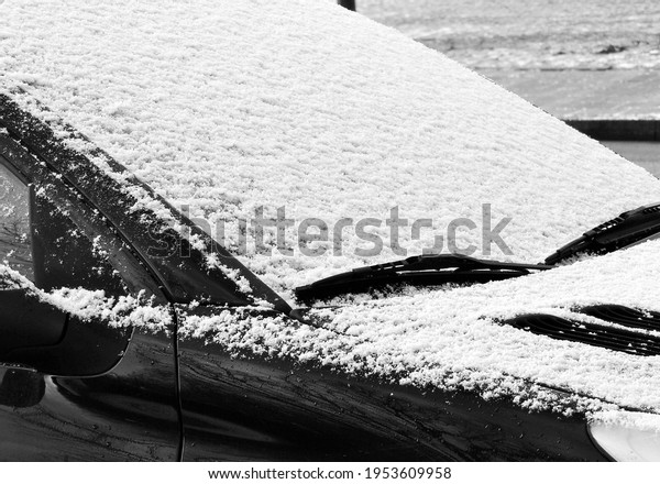a snow covered car in\
winter
