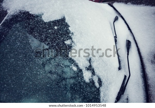 Snow covered car. Winter parking. Rearview mirror\
covered with snow.