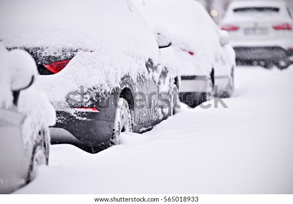 Snow\
covered cars are seen during snowfall in the\
city\
