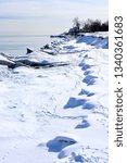 Snow covered cliffs in the Sand Dune Park of Kenosha Wisconsin along the shore of Lake Michigan on a cold January winter day. 