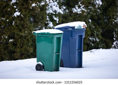 Snow Covered Compost And Recycling Bins On A Residential Curb On Trash Pick Up Day