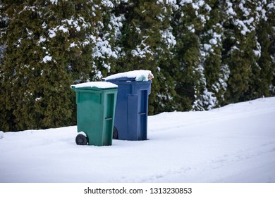 Snow Covered Compost And Recycling Bins On A Street Curb, In A Weather Delay Trash Pick Up Scene