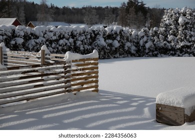 Snow covered fence and shadows. Winter garden. Sunny day - Powered by Shutterstock