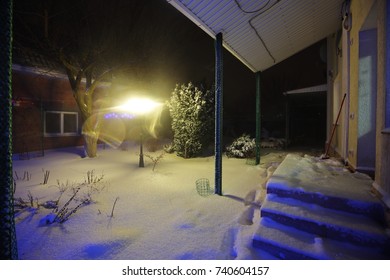 Snow Covered Garden In The Backyard, Winter Night Time.