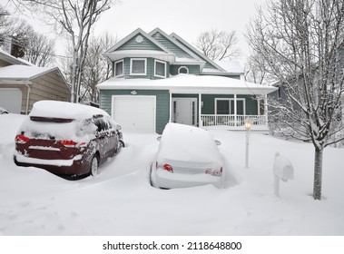 Snow Covered Green Craftsman Style Home In Northeastern Winter Snowstorm In USA