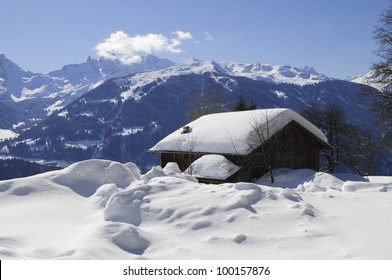 Snow covered house in beautiful mountain landscape in winter. Montafon, Vorarlberg, Austria, Europe.
