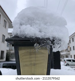 Snow Covered Lamp Post On Snow Covered Column