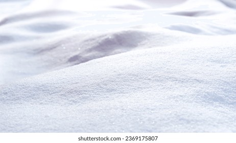 Snow covered landscape, close up shot, bathed in the soft, warm light of winter sunrise. Snow sparkles under the rising sun.
