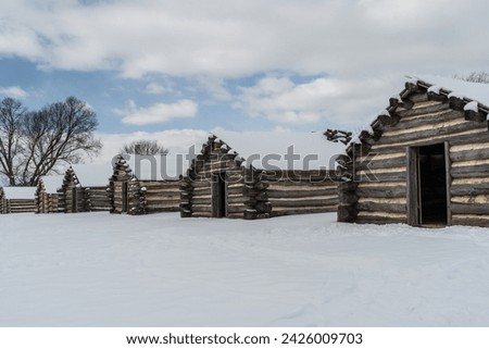 Snow covered log cabins at Valley Forge Historical Park