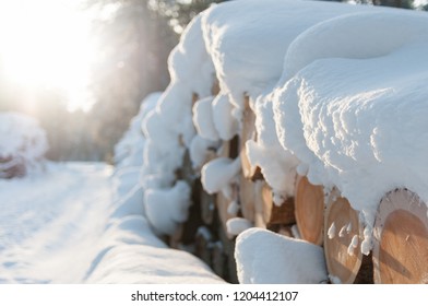 Snow Covered Log Pile.