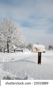 Snow Covered Mailbox Against A Cold New England Winter Landscape