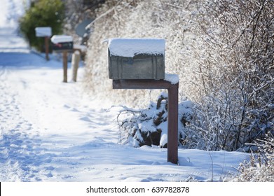 Snow Covered Mailbox. Winter snow caps a mailbox along a country road on Lummi Island   in the San Juan Islands of Puget Sound. - Powered by Shutterstock