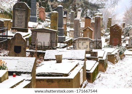 Snow covered monuments in old graveyard, Sighisoara, Romania