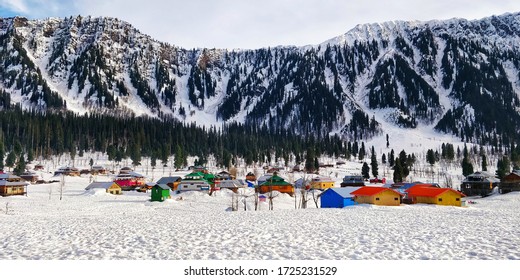 Snow covered mountains with beautiful colorful huts of Arang Kel, Kashmir