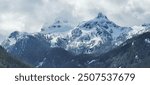 Snow covered mountains with clouds in Whistler, British Columbia, Canada.