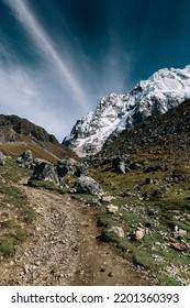 Snow covered Mt Salkantay with large stones and path - Shutterstock ID 2201360393