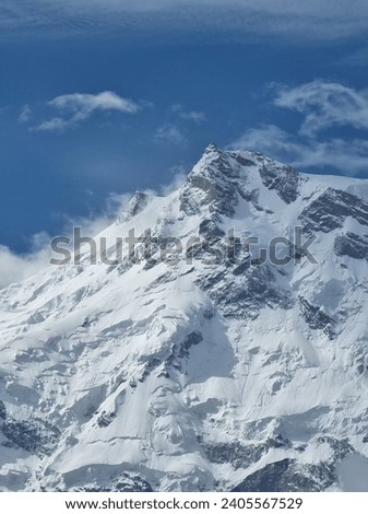 Snow Covered Nanga Parbat Peak of Himalayan Mountain Range. 

Explore the frozen elegance of Nanga Parbat's summit, where the mighty Hima