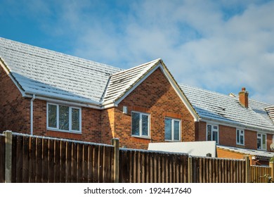 Snow Covered New Built House Roof In England Uk.