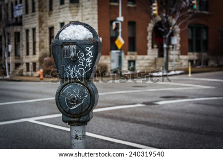 Snow covered parking meter in Charles North, Baltimore, Maryland.