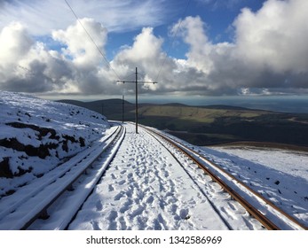 Snow Covered Rail Tracks Of The The Snaefell Mountain Railway, An Electric Mountain Railway On The Isle Of Man. It Joins The Village Of Laxey With The Summit Of Snaefell, At 2,036 Feet Above Sea Level