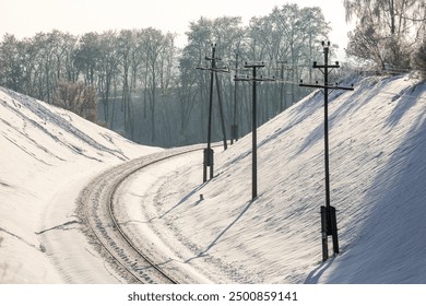 Snow covered railway in winter time. Snow-covered railway tracks. Empty railway in winter. - Powered by Shutterstock