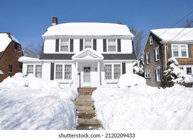 Snow Covered Suburban Gable Front Style Home After Northeastern USA Winter Snowstorm