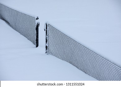 Snow Covered Tennis Court Nets In A Weather Delay Concept, With Space For Text On The Top And Bottom