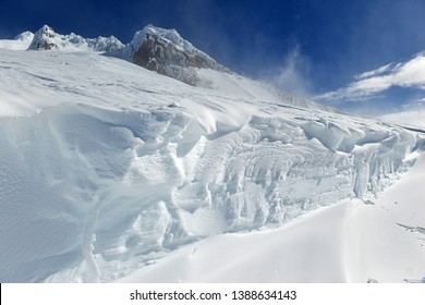 Snow covered terrain on Mount Hood, a volcano in the Cascade Mountains in Oregon popular for hiking, climbing, snowboarding and skiing, despite risks of avalanche, crevasses and weather on the peak.