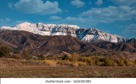 Snow covered Topa bluffs over Ojai Valley farms and vineyards