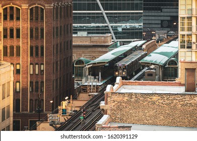 Snow covered train station in the city at sunset. Urban aerial architecture 