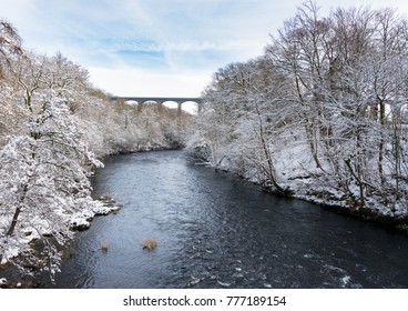 Snow covered trees frame the old Pontcysyllte Aqueduct near Chirk carrying Llangollen Canal across river Dee