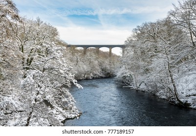 Snow covered trees frame the old Pontcysyllte Aqueduct near Chirk carrying Llangollen Canal across river Dee