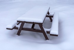 Snow Covered Wooden Picnic Table In Winter.