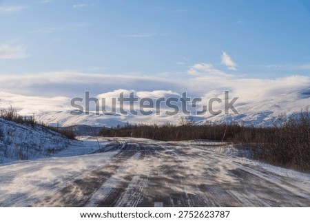Snow drifting on the empty road between Kiruna and Narvik, arctic Sweden, in winter. E10 highway near Abisko