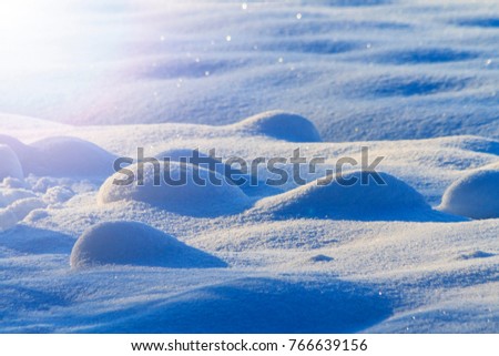 snow drifts with convex hills with sunny hotspot, winter, frosty day