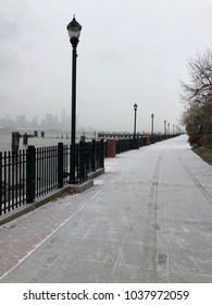 Snow Dust Covers River Walk Along Hudson River With Foggy NYC Skyline