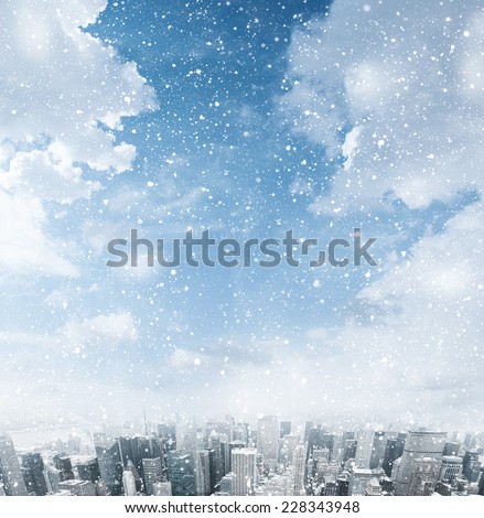 Snow falling down over the city