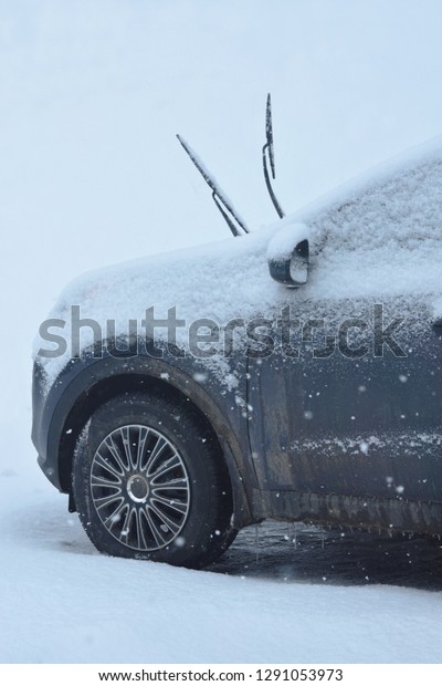 Snow Falling on Dirt\
Covered Salty Gray Car With Its Wiper Blades Up Close Up New\
Brunswick Canada