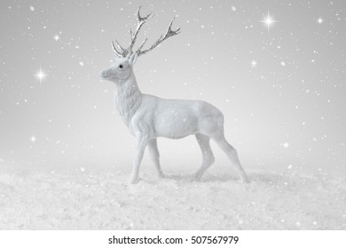 Snow Falling On A White Christmas Reindeer