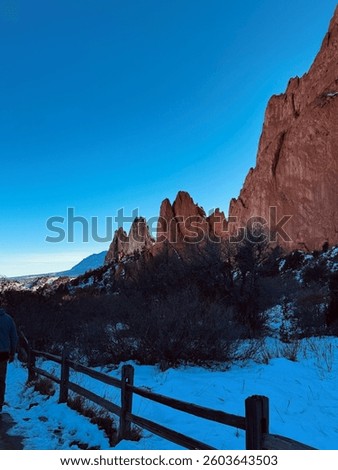 Snow, Fence, and Rock Formations