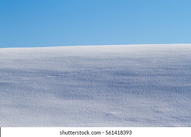 Snow Field And Blue Sky In Winter