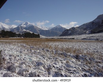 Snow Field, rough snow with snow capped mountains in distance. Copy space in foreground. - Powered by Shutterstock