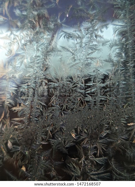 Snow flakes,
frost, ice on a car window in
winter