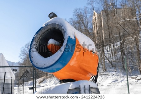 Snow gun device, machine designed for making artificial snow, commonly used at ski resorts and stations. Snowmaking equipment, snow cannon to supplement natural winter snow on the slope or piste.