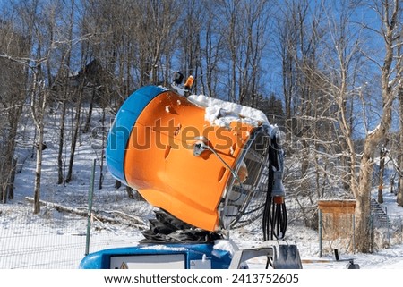 Snow gun device, machine designed for making artificial snow, commonly used at ski resorts and stations. Snowmaking equipment, snow cannon to supplement natural winter snow on the slope or piste.