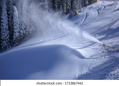 Snow Gun Snow Making Equipment Blowing Snow Deep Powder Onto Trees And A Ski Trail