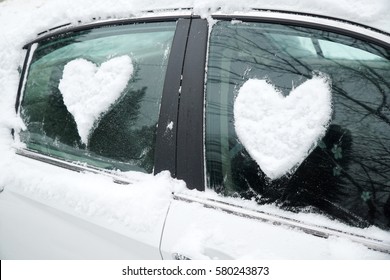 Snow In Heart Shape On Windshield Of The Car